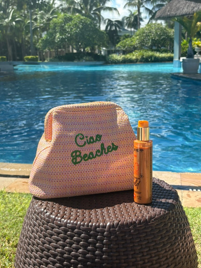 Lilly Loves Ciao Beaches pink clutch pouch with a stylish design, perfect for carrying essentials in a chic accessory.