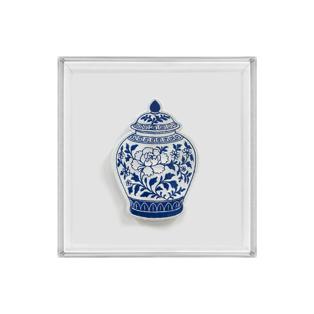 A square white tray with a silver-toned metallic border, featuring a blue and white porcelain-style floral vase illustration in the center.