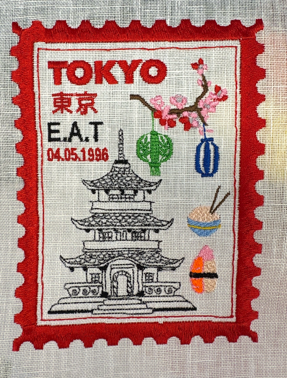 Tokyo inspired embroidered artwork featuring intricate postage stamp design by Lillyloves, displayed on a neutral background.