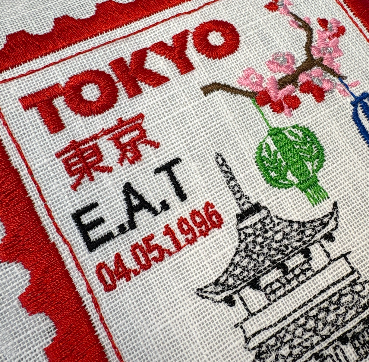 Tokyo-inspired embroidered artwork featuring a postage stamp design by Lillyloves, showcasing intricate embroidery and vibrant details.
