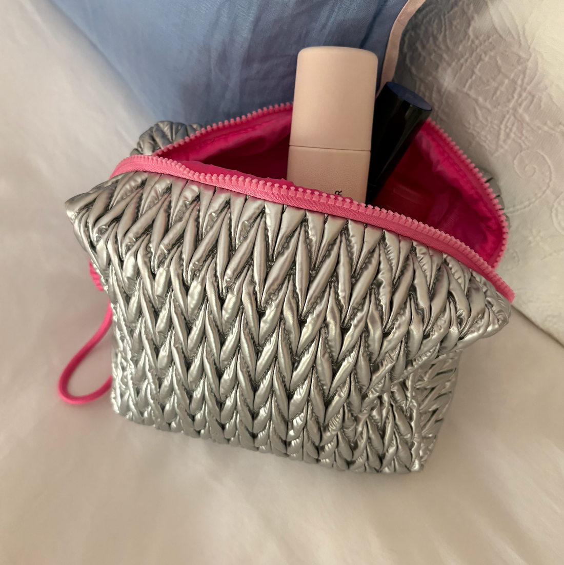 Silver squishy makeup bag by Lillyloves, soft silicone wash bag with a smooth, flexible texture for cosmetics storage.