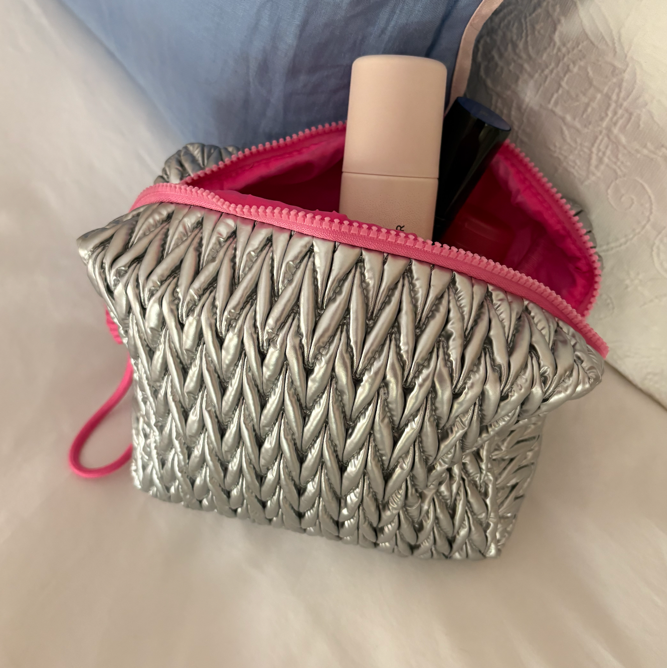 Silver squishy makeup bag by Lillyloves, soft silicone wash bag with a smooth, flexible texture for cosmetics storage.