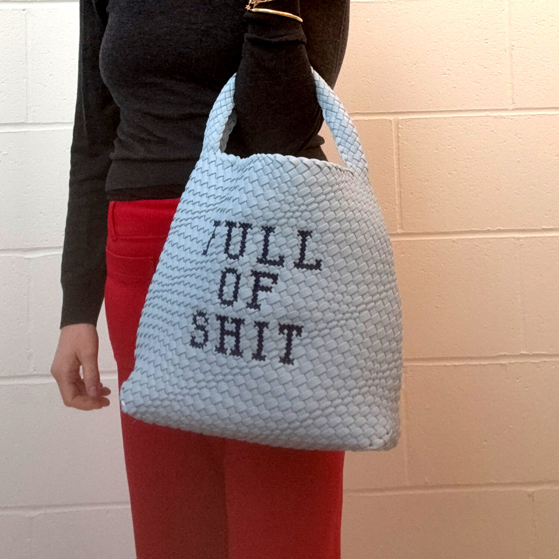 Blue embroidered bucket bag by Lilly Loves, stylish bag with intricate embroidery and spacious interior for organization.