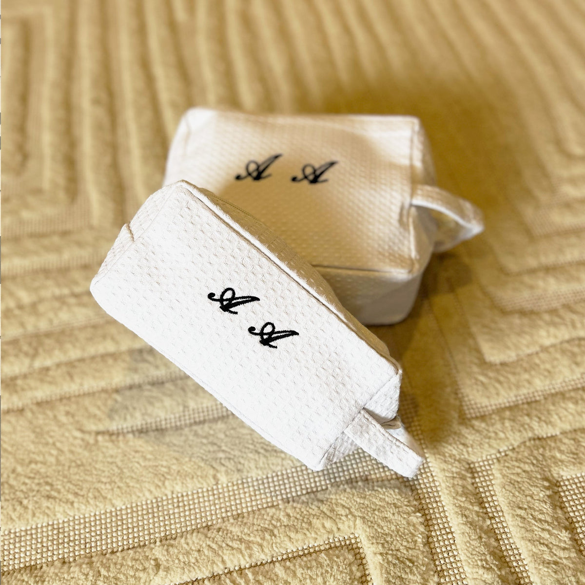 Small Lilly Loves monogramed black and white waffle makeup bag, stylish wash bag with a sleek design.