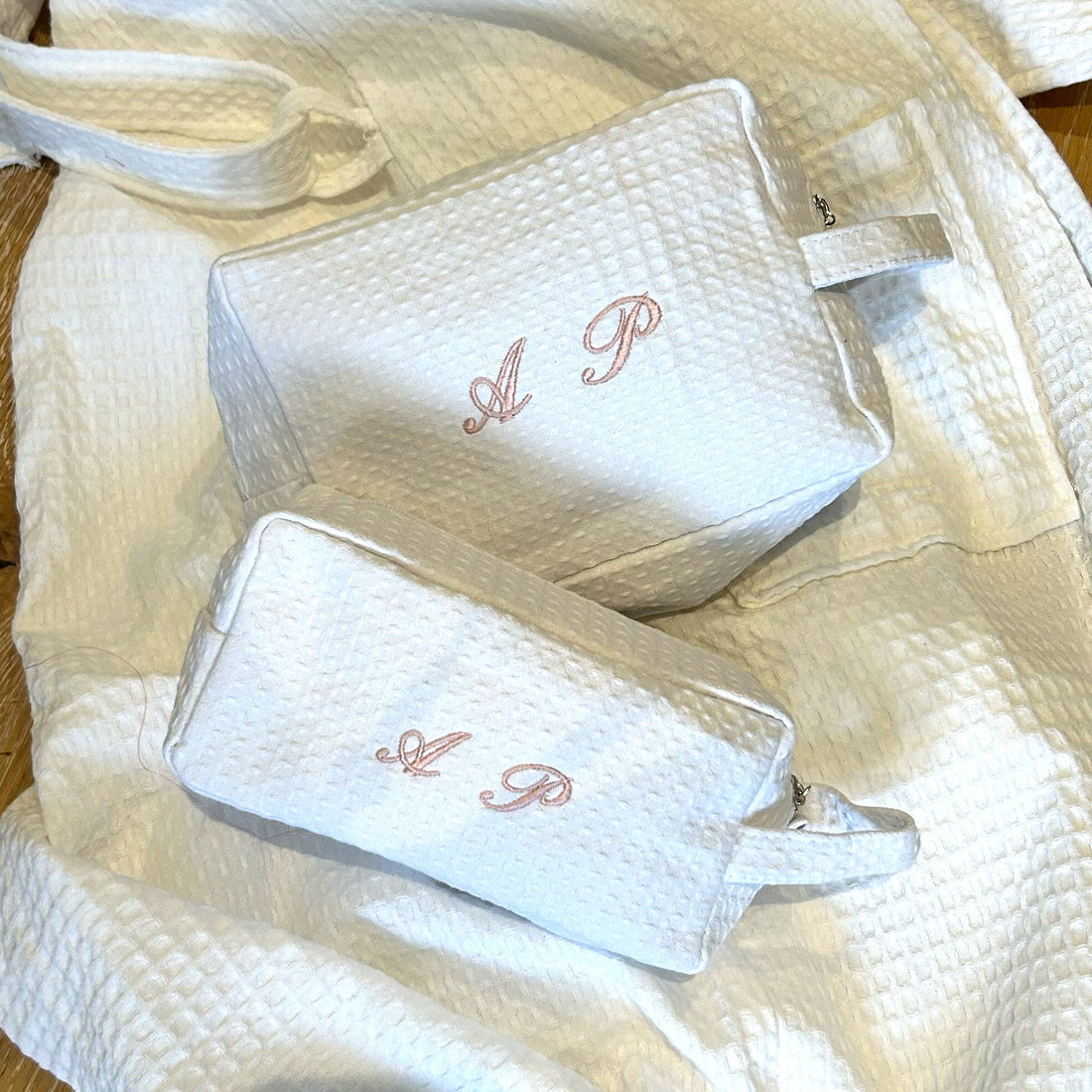 Light pink set of two Lilly Loves monogram quilted cosmetic wash bags with elegant stitching and compact design.