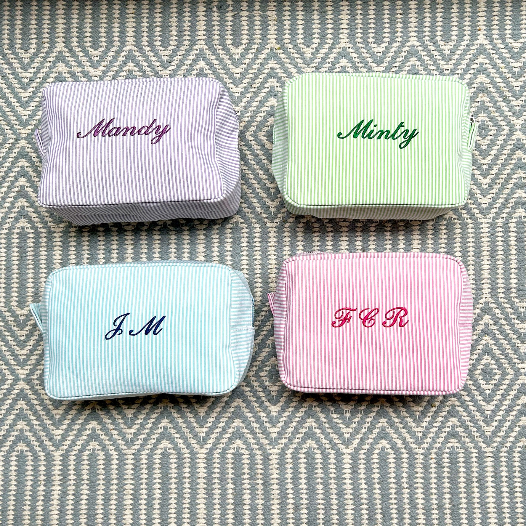 Monogramed stripe cosmetic bag