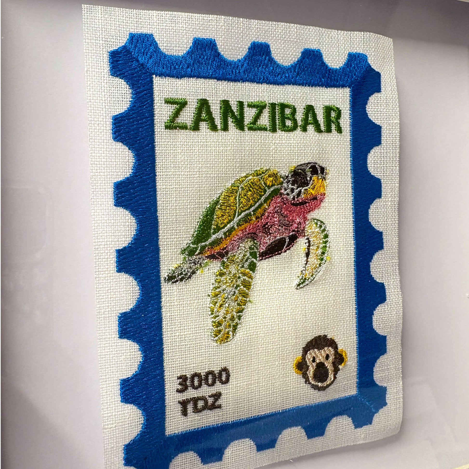 Colorful Zanzibar embroidered stamp artwork by Lillyloves featuring intricate embroidery and vibrant island-inspired design.